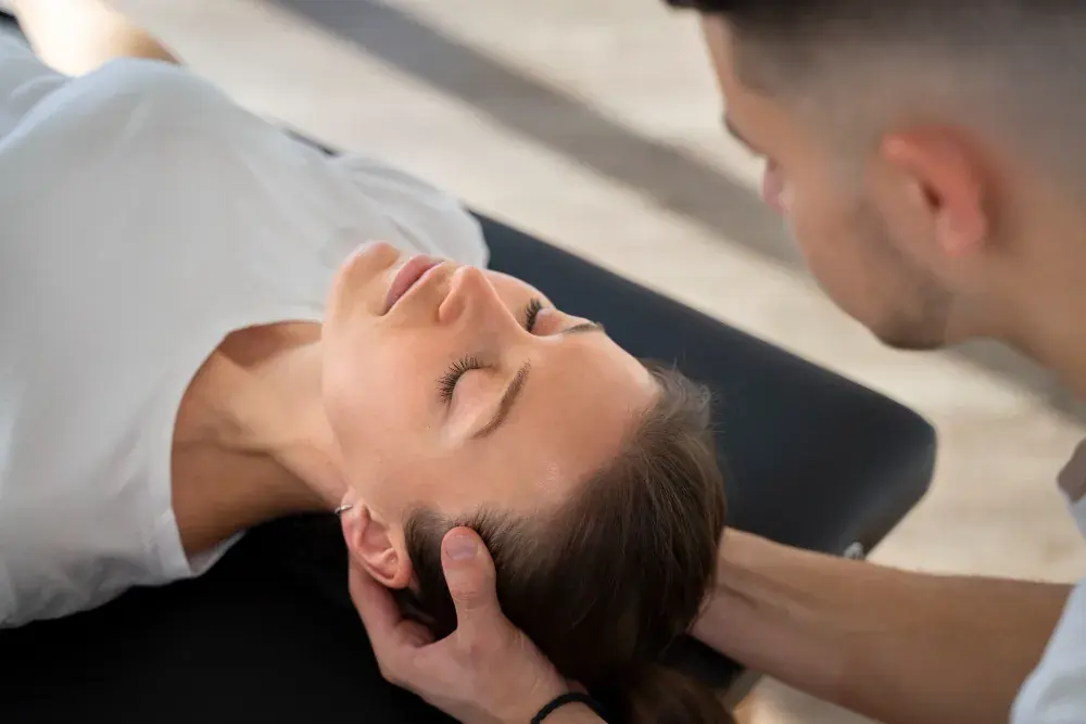 Clinician supporting a patient's head during treatment